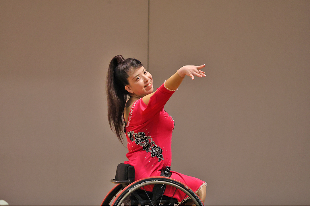 萬木令奈選手。華やかな雰囲気と躍動感が感じられ、鮮やかな赤いドレスや繊細な装飾が目を引き、優雅で表現力や情熱が伝わり、力強さと美しさが調和したエネルギッシュな感じです