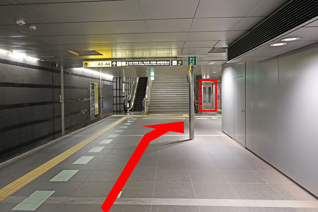 通路の突き当たりのエスカレーターと階段の右奥にあるエレベーター