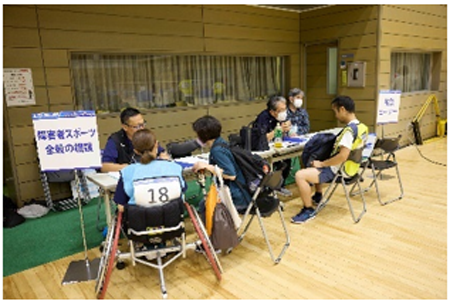 競技相談をしている様子。テーブルを囲んで複数の人たちが座り、落ち着いた雰囲気の中で話し合いや相談をしています。真剣に意見交換や情報共有が行われている様子が伝わってきます