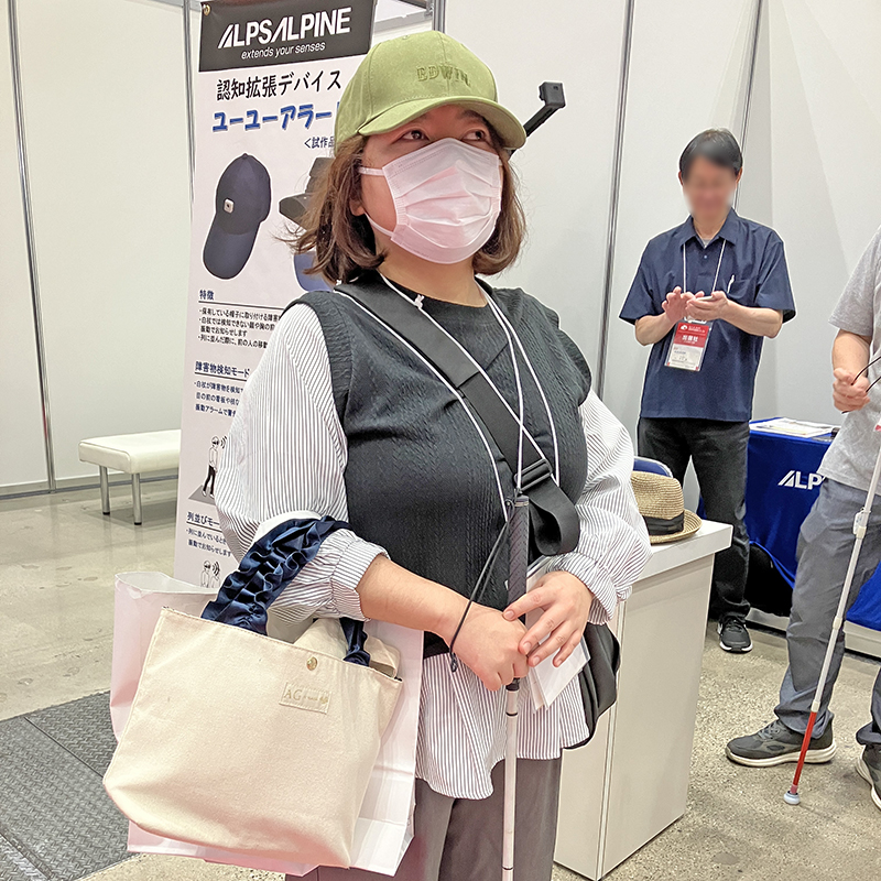 ユーユーアラートを付けたキャップを被り、体験をしている女性