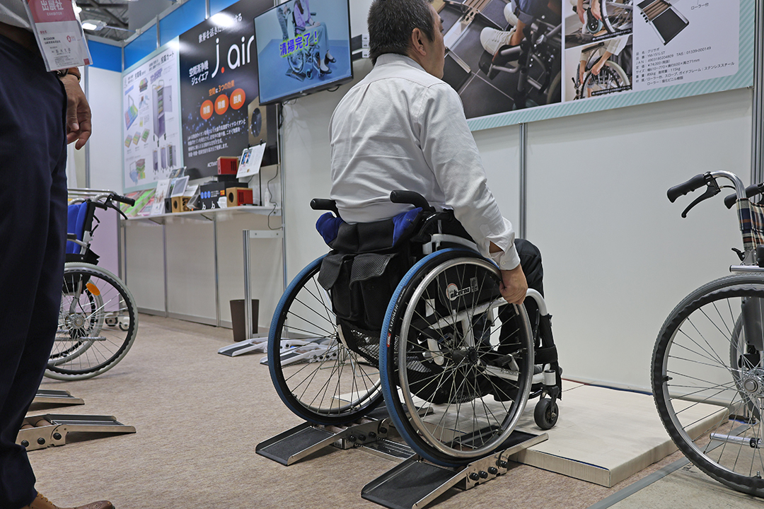 クリサポで車いすの後輪を拭いている様子