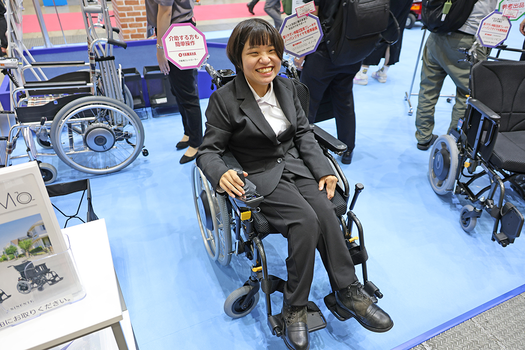 電動化ユニットを装着した車いすに座っている女性